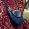Bolso mediano en piel azul. Rowina es un bolso de piel con textura y solapa decorada con tachas y perlas.